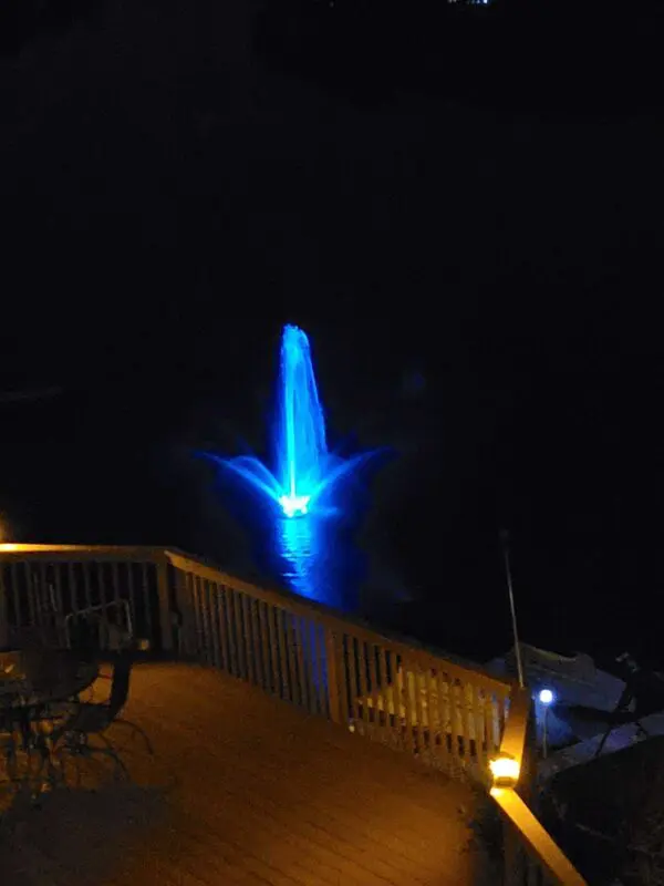 A floating lake fountain with blue lights