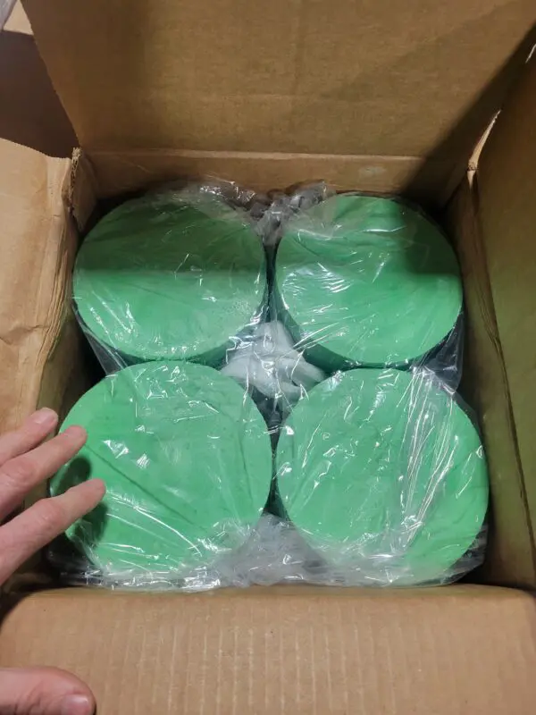 Four green colored boxes inside a carton